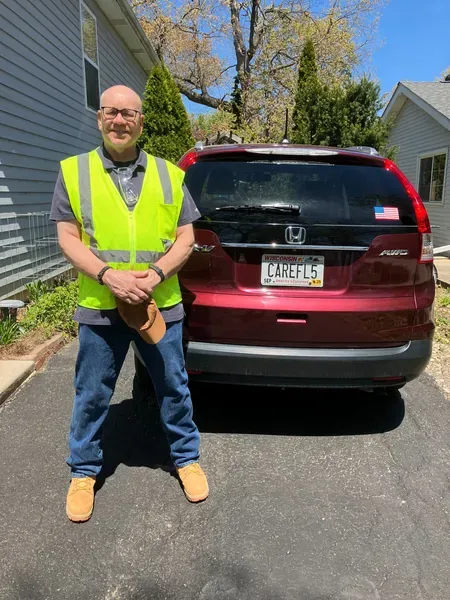 Safety Manager - Leigh Ranta Smiling At Car